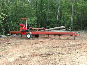 Portable mill set up at customers' wood site